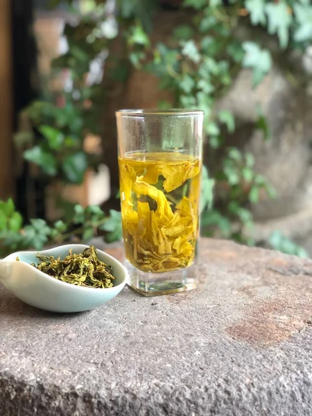 herbal tea with green leaves and fresh herbs