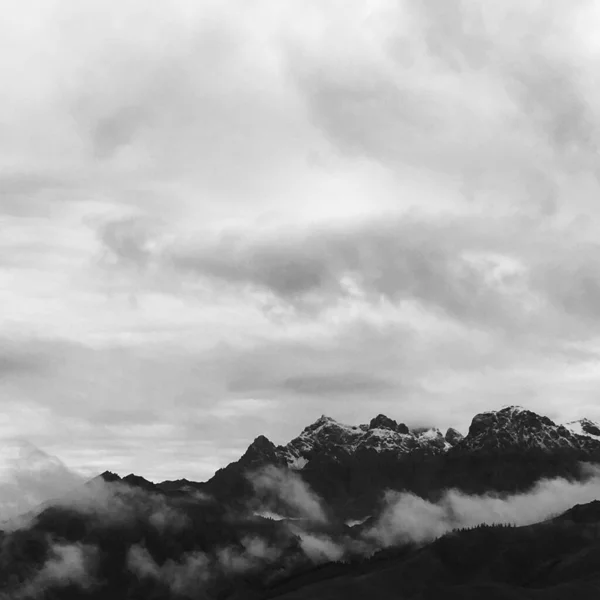 black and white clouds in the mountains