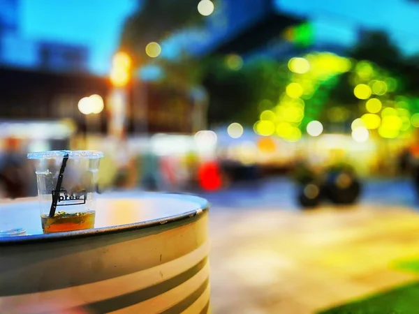 glass of coffee and ice cubes on the street