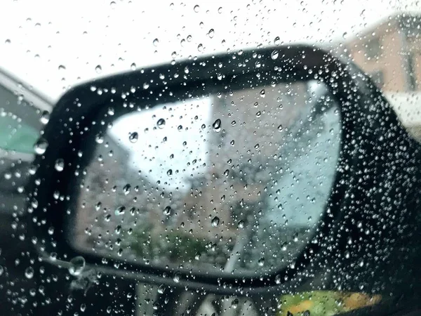 car window with rain drops on glass