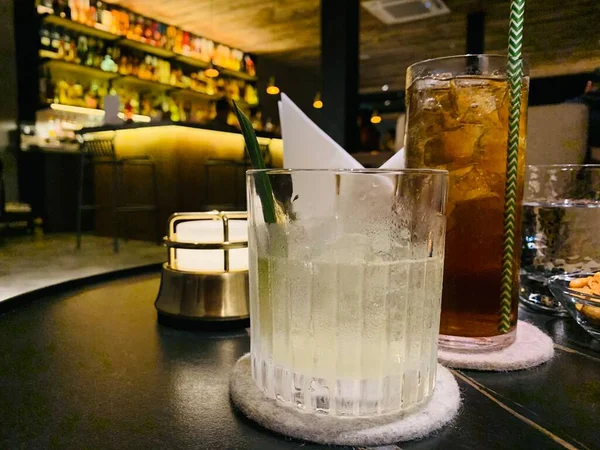 glass of whiskey with ice and lemon on the bar counter