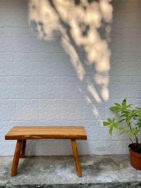empty wooden chair on the wall