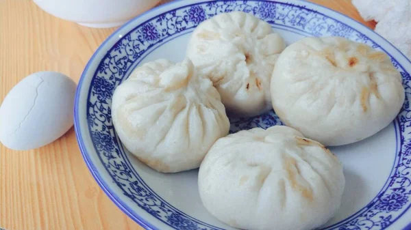 chinese steamed dumpling with egg and sour cream