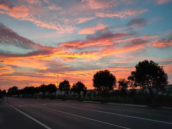 stock image sunset over the road in the city