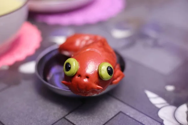 cute frog on a plate with a spoon