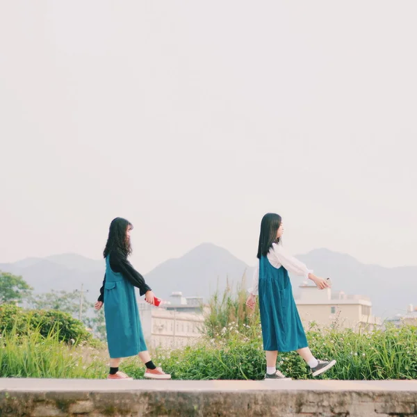 stock image young beautiful mother and her daughter are walking on the beach