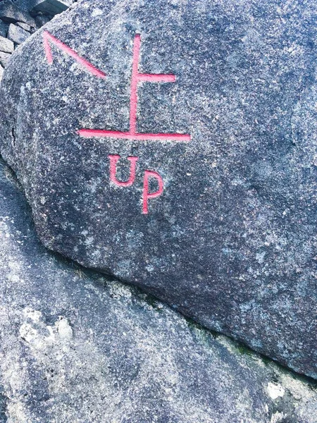 old stone wall with a sign of the word\