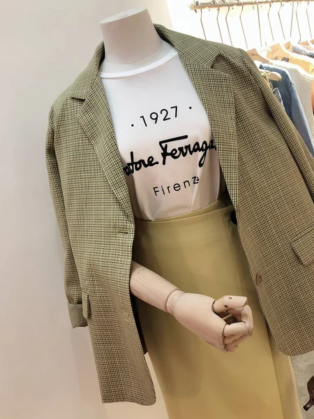 mannequin in a shop with a shirt and a hanger