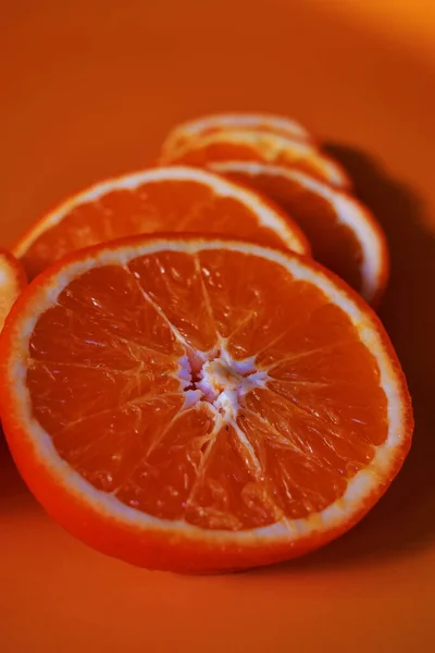 orange and red grapefruit on a white background