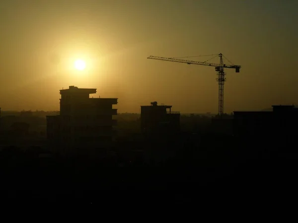 silhouette of a building under construction against the background of the city