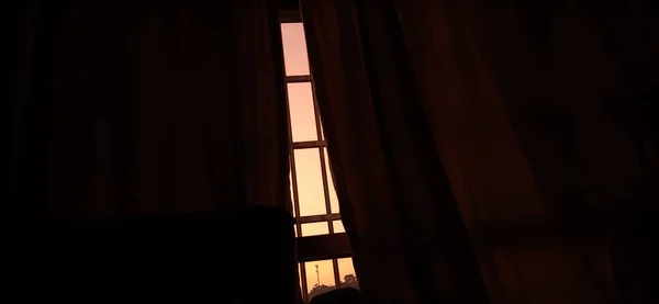 silhouette of a woman in a room with a window