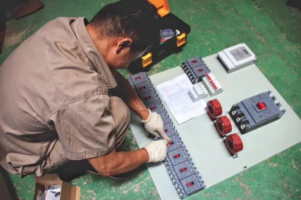 man with a drill on the background of the building