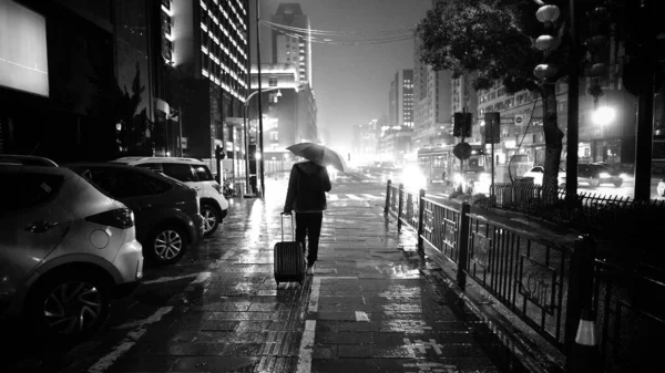 black and white photo of a street in the city