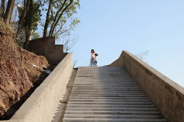 young couple in love walking on the stairs in the mountains