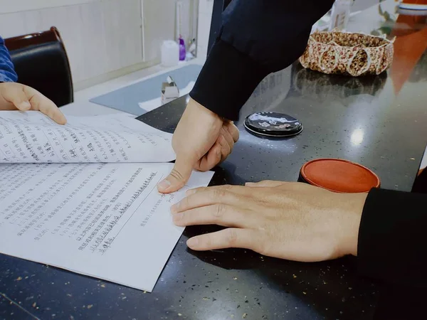 man\'s hand writing on a typewriter