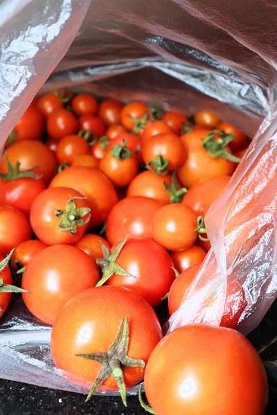 fresh tomatoes in a box on a wooden background