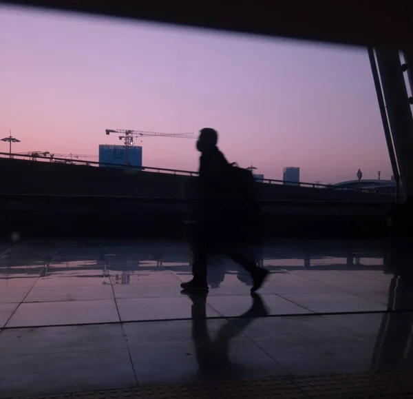 silhouette of a man in a suit and a black dress on the background of the city