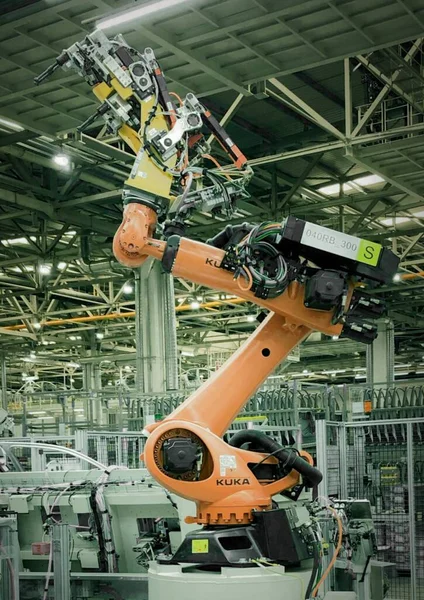 industrial factory, technology, production and people concept-close up of modern robot and equipment