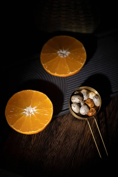 orange and black tea with oranges on a dark background
