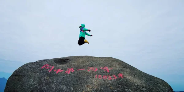 a man climbs a kite on the top of the mountain