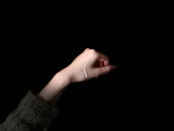 woman\'s hand with a black background