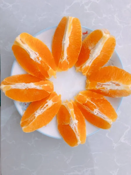 orange slices with a slice of lemon on a white background