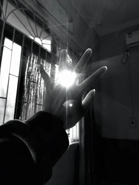 hands of a man in a black suit with a white background