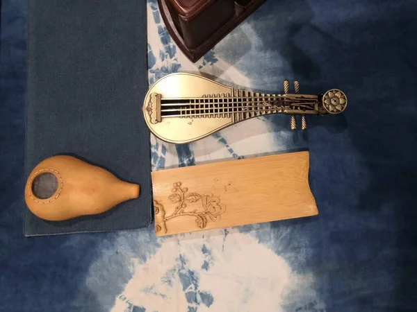 vintage guitar and wine on a wooden table