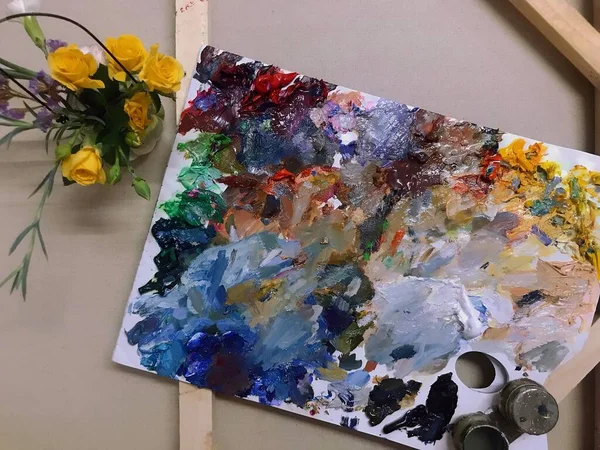 palette of paint and brushes on a white background
