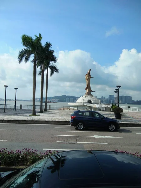 the girl is riding a car on the road