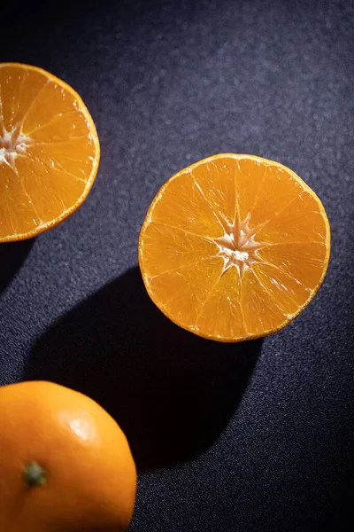 orange and black slices of a lemon on a dark background