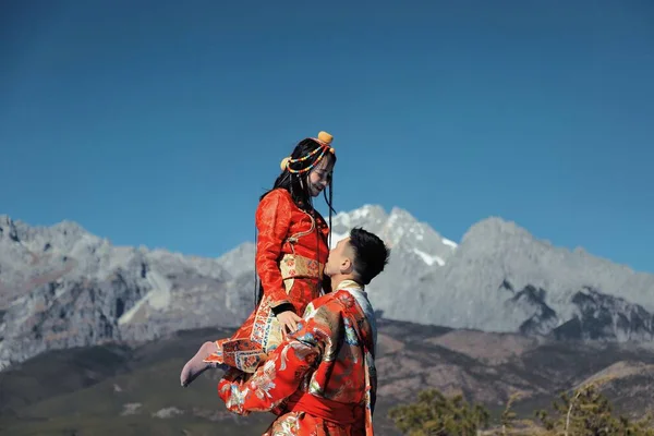 young couple in love on the top of the mountain