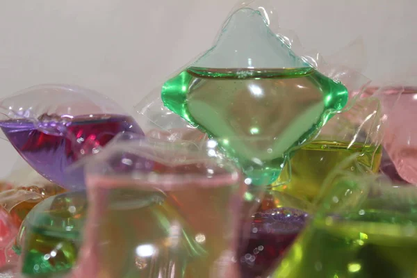 colorful plastic bottles with a glass of water