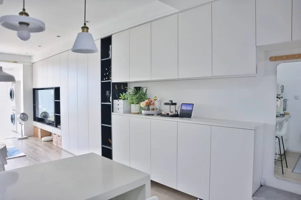 modern kitchen with white and blue walls and a large window