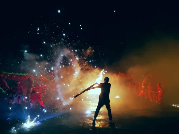 man with a torch on the background of the night sky