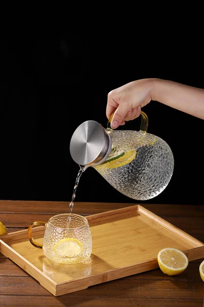 chef pouring lemon juice on a black background