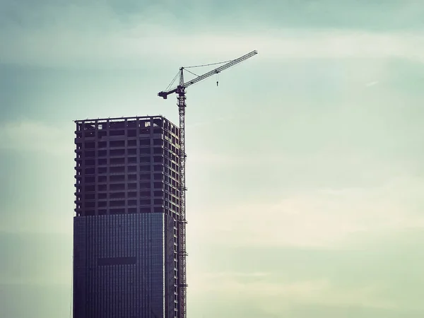 construction of a building against a background of a skyscraper
