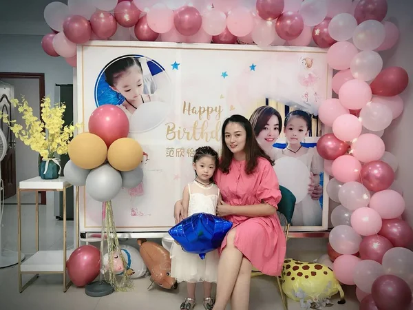 happy family with balloons in the room