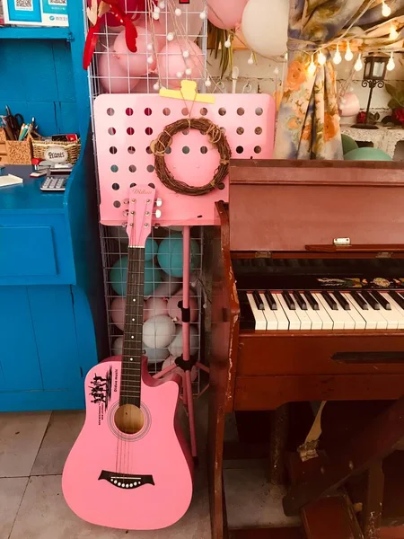 vintage piano with a red guitar