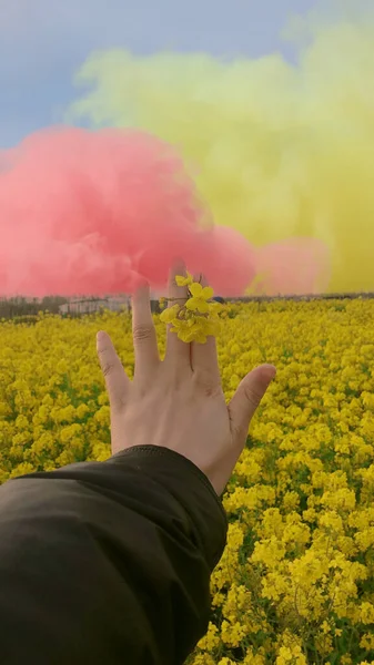 a man in a yellow shirt is holding a flower in her hands.