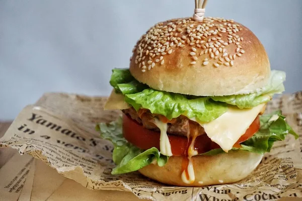 homemade burger with chicken, tomato and lettuce, close-up