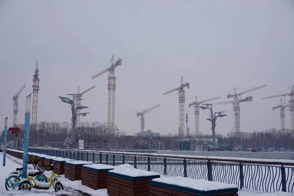construction site with cranes and snow