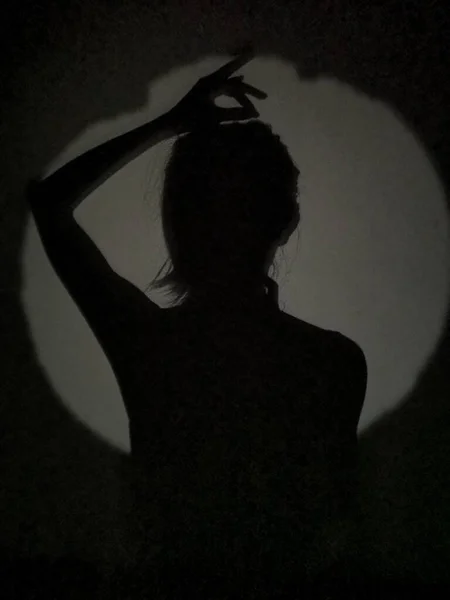 silhouette of a woman in a black dress