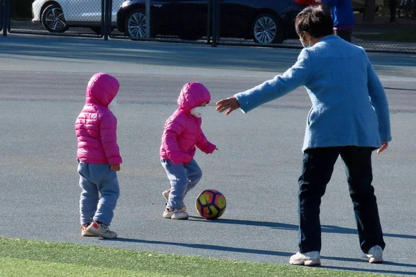 children playing with a ball in the park