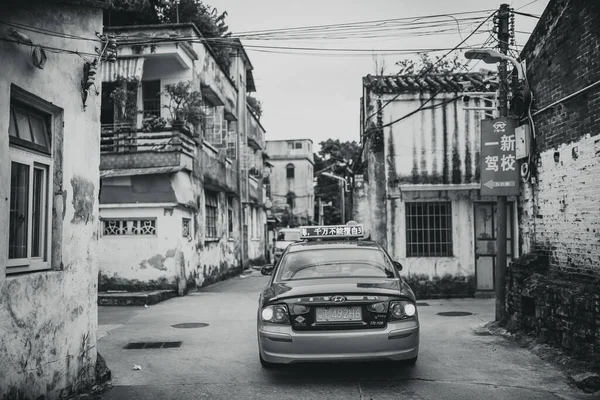 black and white photo of a street in the city