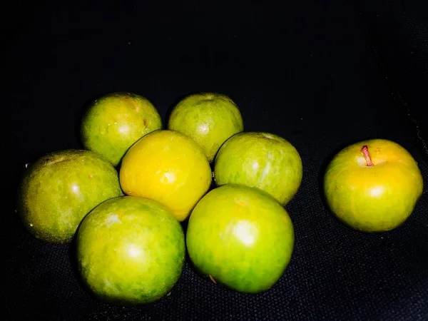 green apples on black background