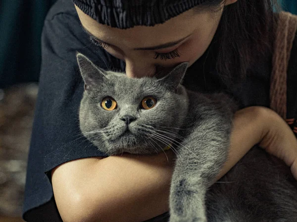 portrait of a beautiful young woman with a cat