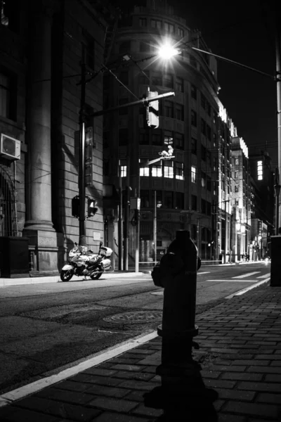 black and white photo of a street in the city