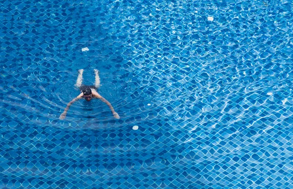 young woman in blue bikini swimming in water