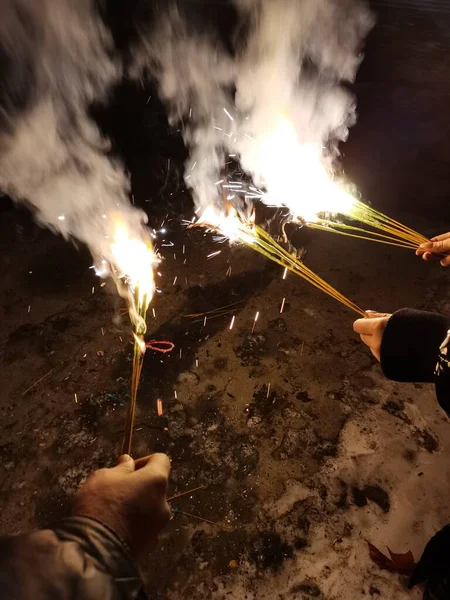 close up of man\'s hands holding a burning torch